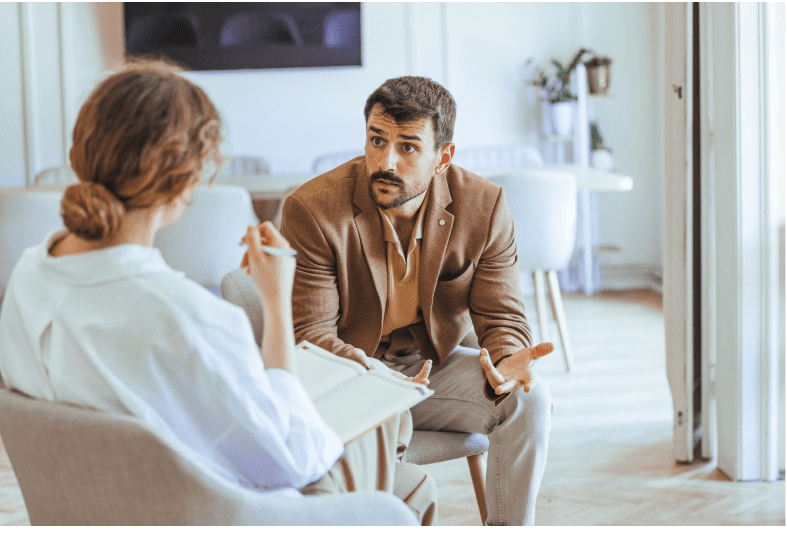 Man and woman discussing in office setting