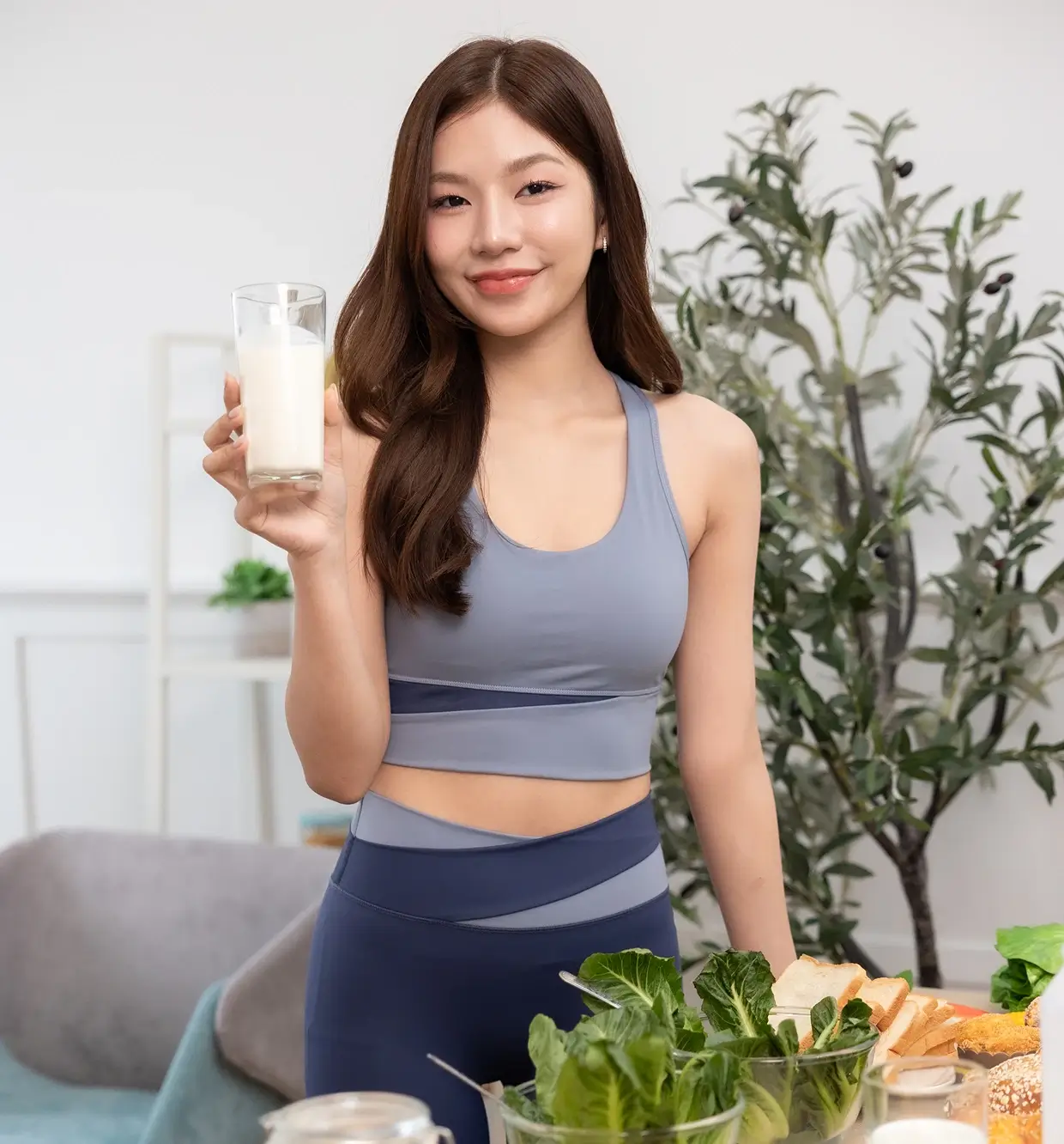 Smiling woman with nutritious meal and milk