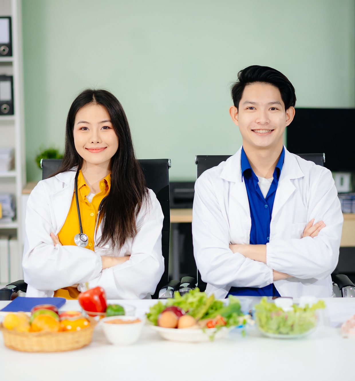 Doctors smiling with healthy food display