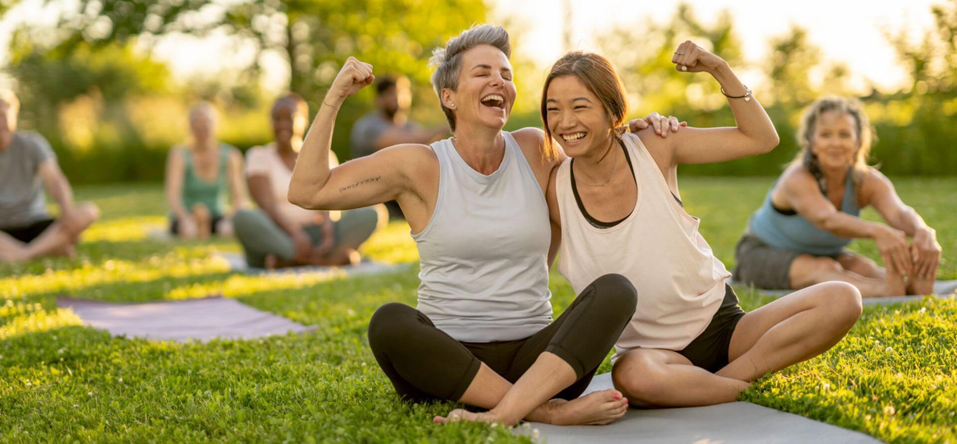 Happy yoga participants seated on mats