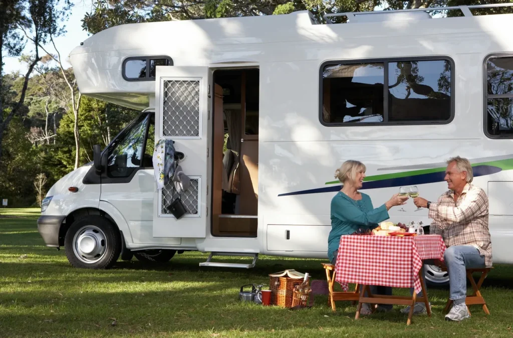 Couple enjoying picnic by motorhome