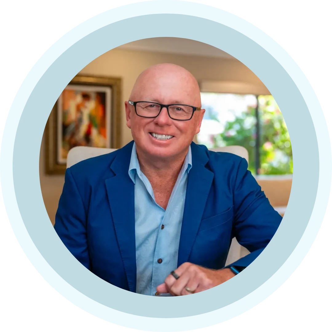 Smiling bespectacled man in blue blazer