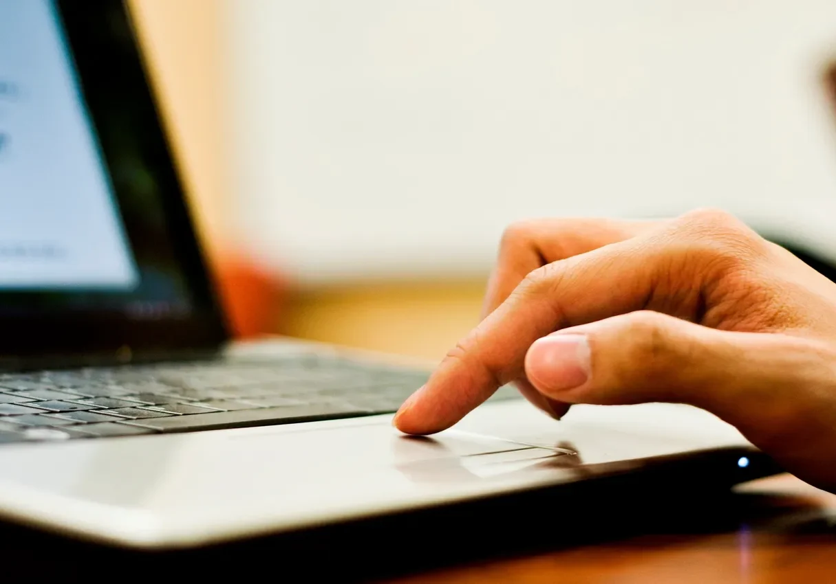 Hand using a laptop touchpad