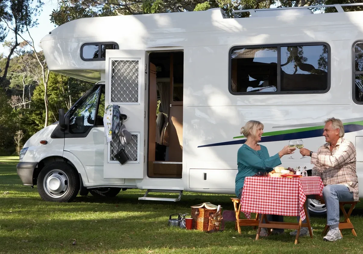 Couple enjoying picnic by motorhome