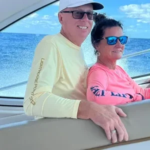 Smiling pair on a yacht at sea